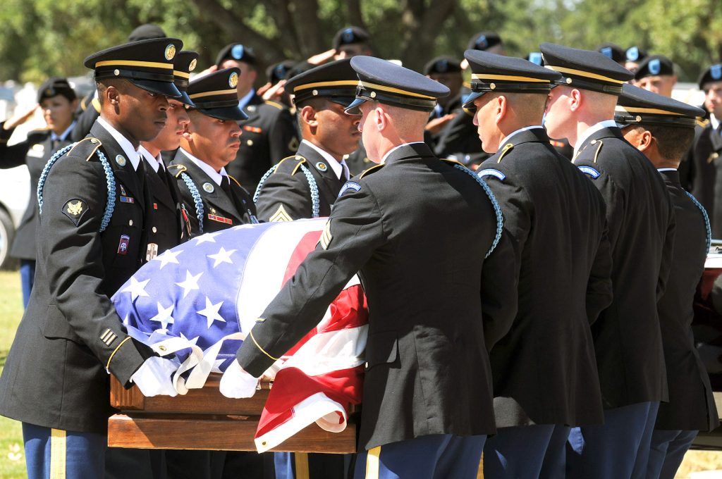 Military Honor Guard Services at Fort Sam Houston - Military Personnel carry a casket with an American flag draped over